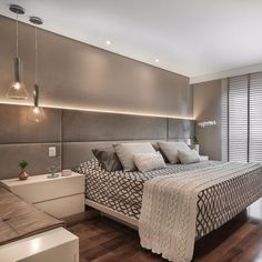 a large bed sitting in the middle of a bedroom next to a wall mounted tv