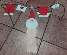 paper cut out of santa's clothes hanging on a line