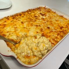 a large casserole dish with cheese and meat in it on a white table