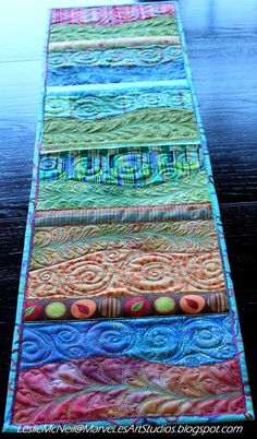 a table runner made out of colorful fabrics