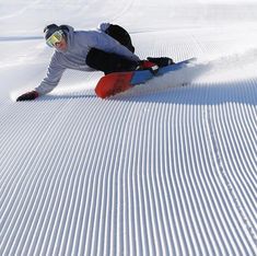 a man riding skis down the side of a snow covered slope