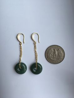 A gorgeous pair of dark green jade donut earrings. The royal style long dangles gold earrings, paired with the vintage green jade circles are eye-catching and elegant. Hade made with high-quality materials only and comes in the gift-worthy package, perfect as a gift for yourself or your loved ones. Some highlights of this pair of breath-taking natural green jade drop earrings are: *High-quality guaranteed Hand made with grade-A natural dark green jade. The chain is gold plated, ensure long lasti Round Jade Jewelry With Matching Earrings, Green Round Pendant Earrings For Gift, Single Green Round Earring, Green Single Round Earring, Vintage Jade Round Earrings, Jade Dangle Earrings Jewelry Set, Dangle Jade Earrings With Matching Set, Jade Dangle Earrings For Pierced Ears, Pierced Jade Dangle Earrings