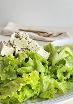 lettuce and tofu on a white plate