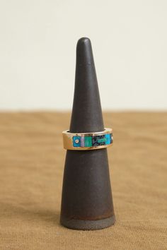 The Composition Inlay Ring is a handmade work of art from Young in the Mountains. Its distinctive band is adorned with a variety of stunning inlaid stones, including Turquoise, Black Dino Bone, Chrysocolla, and Burro Creek Jasper from Western America. Scattered throughout the inlay are reclaimed diamonds, further adding to the uniqueness and excellence of this exquisite piece. Artisan Multi-stone Ring Jewelry, Artisan Multi-stone Ring, Unique Turquoise Multi-stone Opal Ring, Unique Turquoise Opal Ring With Multi-stone Design, Unique Inlay Ring Jewelry, Modernist Multi-stone Ring, Artisan Chrysocolla Gemstone Rings, Western America, Commitment Rings