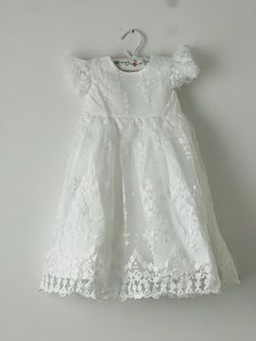 Beautiful and elegant baby girls' lace baptism dress. Two-piece set including a delicately embroidered cap-sleeve gown with matching lace bonnet. Complete with a linen and cotton blend liner, to ensure comfort. Feel free to add one of our adorable headbands to complete the look. White Lace Dress For Baptism In Spring, White Lace Dress For Spring Baptism, White Cap Sleeve Dress For Wedding, Spring Baptism Dress With Lace Bodice For First Communion, White Lace Baptism Dress For Spring, Short Sleeve Lace Dress For Baptism In Spring, Fitted Baptism Dress With Lace Work For Spring, Lace Baptism Dress With Ruffles And Short Sleeves, Lace First Communion Dress With Ruffles For Ceremony