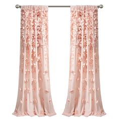 pink curtains with flowers on them hanging in front of a white wall