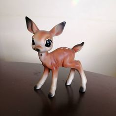 a small deer figurine sitting on top of a table