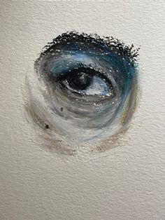 an eye painted in white and blue on a piece of paper with watercolor paint