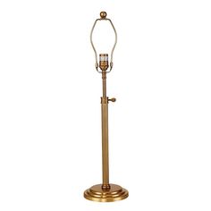 an antique brass finish floor lamp on a white background