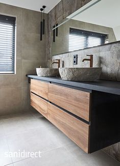 a bathroom with two sinks and a large mirror