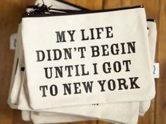 three small pouches with words on them that say, my life didn't begin until i got to new york