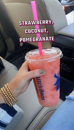 a person holding a drink in their hand with the caption strawberry, coconut, pomegranate