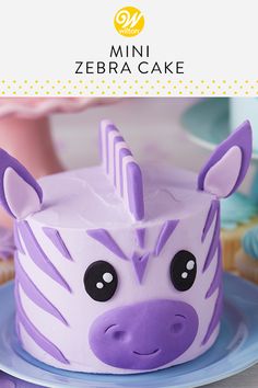 a purple zebra cake sitting on top of a blue plate