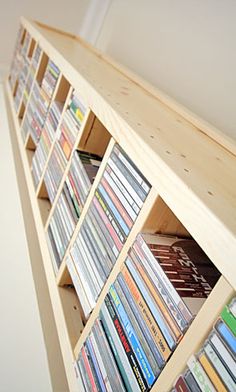 a wooden shelf filled with lots of dvd's