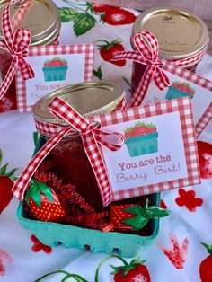 strawberry jam in a jar with tags and strawberries on the tablecloth for valentine's day