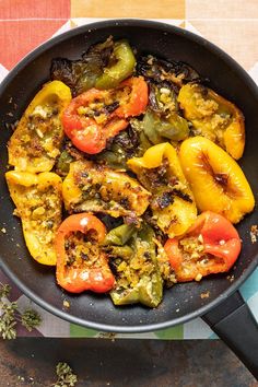 a skillet filled with cooked peppers on top of a table