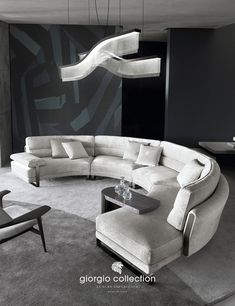 a modern living room with curved couches and chandelier hanging from the ceiling