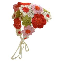 a crocheted hat with flowers on it is shown in red, white and green