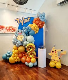 the balloon arch is decorated with pikachu and other pokemon characters for a birthday party