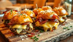 mini burgers with cheese and bacon on a cutting board