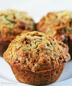 three muffins sitting on top of a white plate