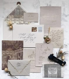 an assortment of wedding stationery and envelopes