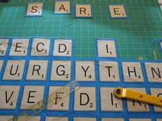 a pair of scissors are laying on top of scrabble tiles that spell out the word search