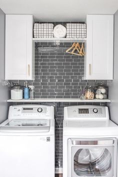 a small laundry room with washer and dryer next to each other on the wall