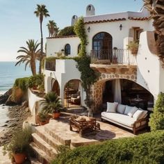 a house on the beach with palm trees