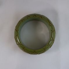 "Rare \"Crocodile\" pattern carved pea-green bakelite chunky bangle This is a beautiful, extremely rare bracelet on consignment to me. The bracelet is 1-5/16\" wide and the inside circumference is 8 inches around. The inside diameter measures 2.533 across and the outside diameter is 3.43 inches The bracelet is pea green with striations of yellow and browns. I've rotated the bracelet in the pictures so that you can see it from all sides" Green Crocodile, Skin Pattern, Crocodile Pattern, Crocodile Skin, Printer Ink, Yellow And Brown, Blue Stone, Peas, Bangles