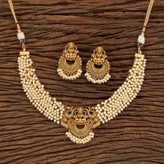 South Indian Bridal Traditional with matte gold plating Necklace Set with Earrings. Temple choker set. Gorgeous 24 K gold plated. This Necklace set comes in a beautiful gift box, making it an ideal gift for birthdays, weddings or anniversaries. Occasion: Perfect choice for any Indian occasion. Care: It is advisable that you keep products away from direct heat, humidity, and moisture. It is best to preserve your jewelry in the bag/box provided with the package. 100% Satisfaction Guarantee, Highes Gold Chandbali Pearl Necklace In Temple Jewelry Style, Gold Chandbali Pearl Necklace In Temple Style, Gold Chandbali Jewelry Sets For Rituals, Gold Jewelry Sets With Latkans For Rituals, Gold Pearl Necklace With Latkans Temple Style, Gold Chandbali Pearl Necklace For Puja, Festive Gold Brass Temple Necklace, Festive Yellow Gold Brass Temple Necklace, Handmade Gold-plated Temple Necklace