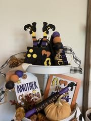 a basket filled with halloween decorations on top of a white table next to other items