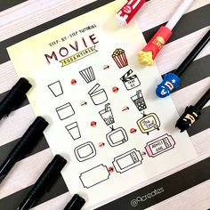 the movie worksheet is next to some candy and pens on a striped tablecloth