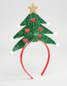 a green christmas tree headband with red hearts and gold stars on the top, sitting in front of a white background