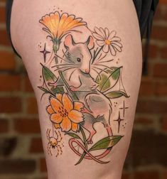 a woman's thigh with flowers and a mouse on it