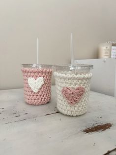 two crocheted cups sitting on top of a table