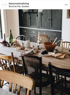 a dining room table is set with dishes and utensils