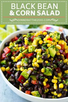 a white bowl filled with black beans, corn and avocado garnish