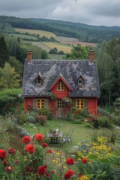 a red house surrounded by flowers and trees