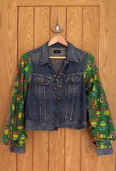 This vintage denim jacket is a one of a kind piece crafted from thrifted denim. The jacket's back panel features a Mutant Ninja Turtles cutout.  The lower pockets and top pockets are both fully functional and it has metal snap buttons to close. This jacket is ideal for Mutant Ninja Turtles fans and vintage fashion lovers, and is sure to be a standout piece in any wardrobe. This is a thrifted 'Lee' denim jacket with the size missing, although it appears to be a small.  Note: this store uses thrif Fitted Recycled Denim Jacket With Pockets, Fitted Denim Jacket With Pockets In Recycled Denim, Fitted Denim Jacket With Patch Pockets, Fitted Denim Jacket With Patch Pockets And Long Sleeves, Cotton Patchwork Denim Jacket With Relaxed Fit, Fitted Long Sleeve Denim Jacket In Recycled Denim, Trendy Fitted Recycled Denim Jacket, Trendy Fitted Denim Jacket In Recycled Denim, Fitted Cotton Denim Vest With Patchwork