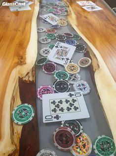 a long table with many different types of buttons on it and some cards in the middle