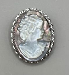 "Featuring this beautiful hand, carved shell cameo brooch/pendant in a sterling silver setting. It measures 1 1/8\" x 1 7/8\" and is in excellent vintage condition.  The brooch/pendant is hallmarked \"sterling\"." Oval Silver Cameo Brooch, Carved Shell, Cameo Brooch, Pin Pendant, Glass Bead Necklace, Beautiful Hand, Sterling Silber, Blue Glass, Brooch Pin