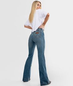 Wrangler® Retro® Trouser Stretch Jean - Blue 27/32, Women's Shelby High rise Slim through the hip and thigh 20 bottom opening Destructed pocket and hem detail Due to the unique wash process there will be a color varaince with each piece Shoe sku 952102 Model Info: Height: 5'6 | Bust: 33 | Waist: 27 | Hip: 36 | Wearing Size: 25x34. This quality denim is hand-finished for a unique look. It will wear like your favorite jeans, with each hole and tear continuing to destruct over time. You will love t Jeans Ads, Wrangler Jeans Women's, Clothes Country, Mom Fits, Retro Trousers, 2022 Outfits, Western Fits, Western Wear Outfits, Cute Country Outfits