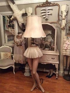 a mannequin is standing in front of a lamp