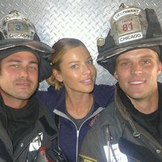 three fire fighters posing for a photo together