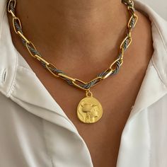 The Athena Choker Necklace is a stunning piece inspired by the wisdom and strength of the goddess Athena. At its heart is a replica of an ancient Greek coin, featuring Athena on one side and Nike, the goddess of victory, on the other, symbolizing both wisdom and triumph. The necklace is crafted with a luxurious 24k gold-plated rolo chain, measuring 16” in length, making it the perfect choker style. Adding a touch of modern elegance, the chain is interwoven with a delicate silk cord, available in Nike The Goddess Of Victory, The Goddess Of Victory, Goddess Athena, Goddess Of Victory, Ancient Greek Coin, Athena Goddess, Greek Coins, Choker Style, Silk Cord