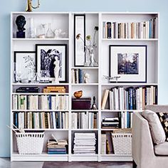 a living room filled with furniture and bookshelves covered in lots of different types of books