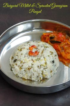 a silver plate topped with rice and vegetables