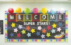 a welcome sign is hanging on the wall in front of balloons and paper lanterns that say,'welcome super stars '