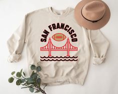 ⚾️ This Vintage SF football sweater is the perfect gift for yourself or any San Francisco football fan! ⚾️ This custom design unisex throwback retro crewneck sweatshirt is perfect for game day!  👕 Printed on a Ultra Comfy Gildan 1800 Cheap Sweatshirt With Logo Print For Fan Gear, Cheap Logo Print Sweatshirt For Fans, Cheap Logo Print Sweatshirt For Fan Gear, Cheap Fan Gear Sweatshirt With Logo Print, Retro San Francisco, Baseball Sweater, Cute Game, Football Sweater, Cute Gifts For Her